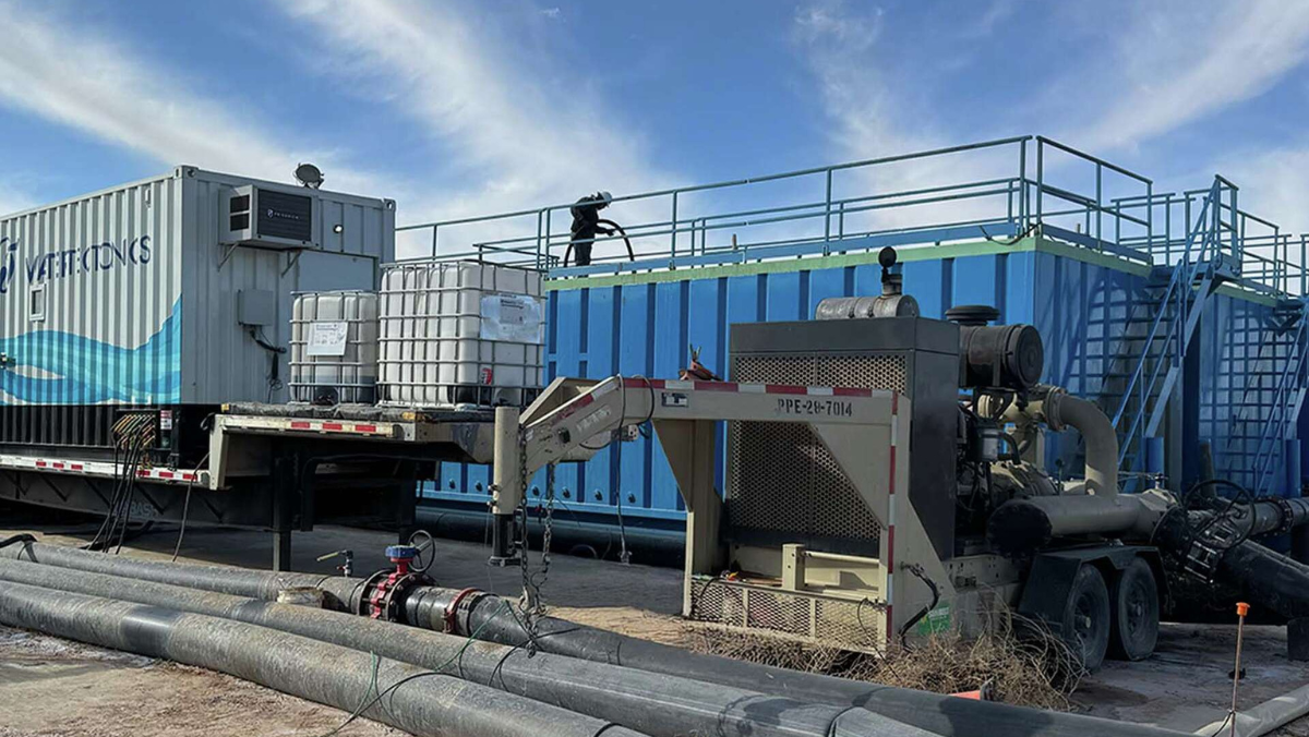 Water recycling equipment and treatment units operating beside large storage tanks in a shale field.
