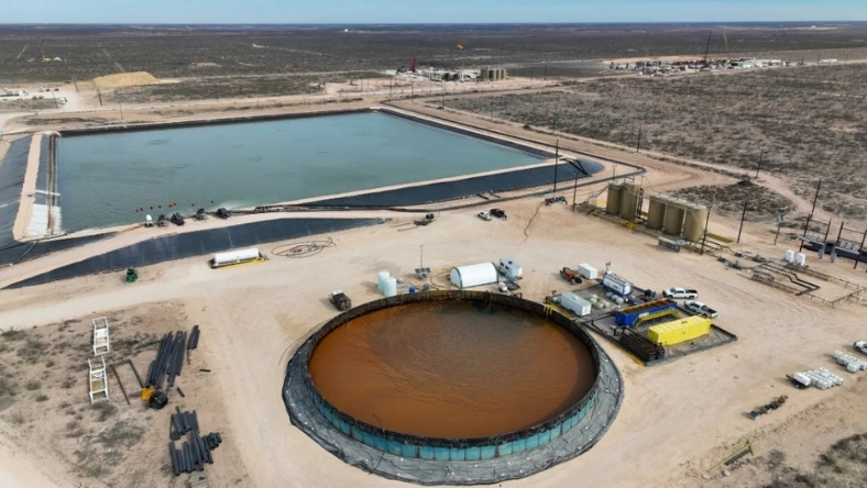 Brine ponds and industrial processing facility in arid oilfield landscape