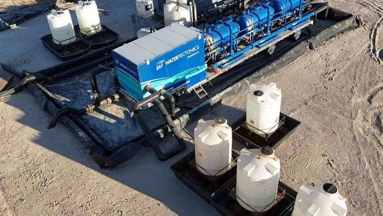 Mobile water treatment unit with storage tanks at oilfield site